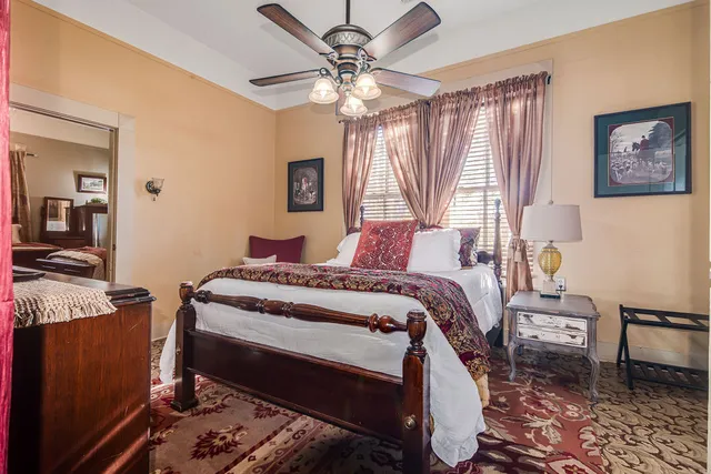 a bedroom with a bed and a chandelier