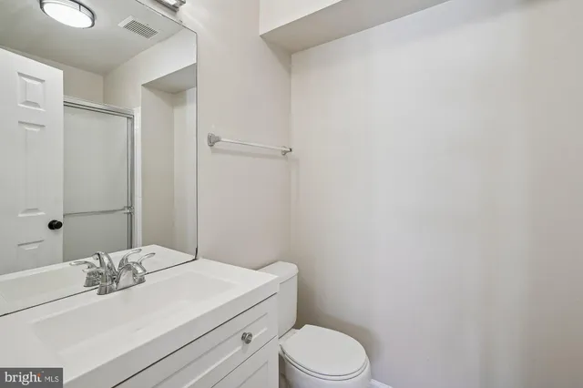 a bathroom with a sink a toilet and vanity