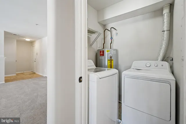a view of storage and utility room with washer and dryer