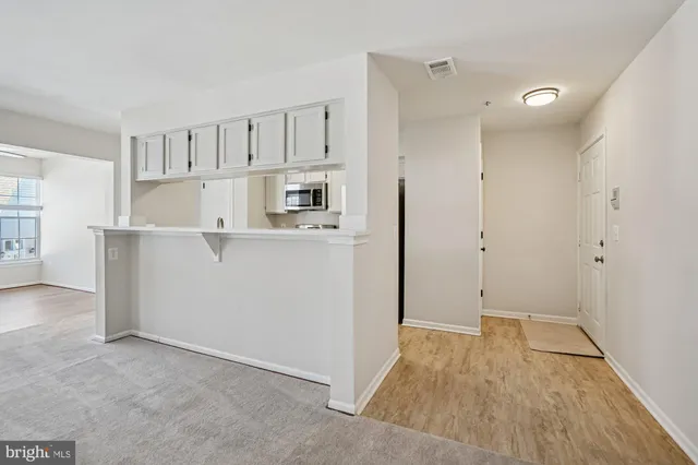 a view of kitchen with white cabinets