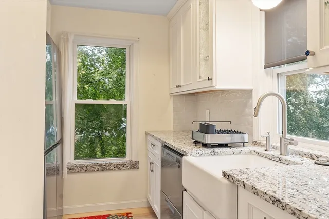a kitchen with granite countertop a sink and a stove