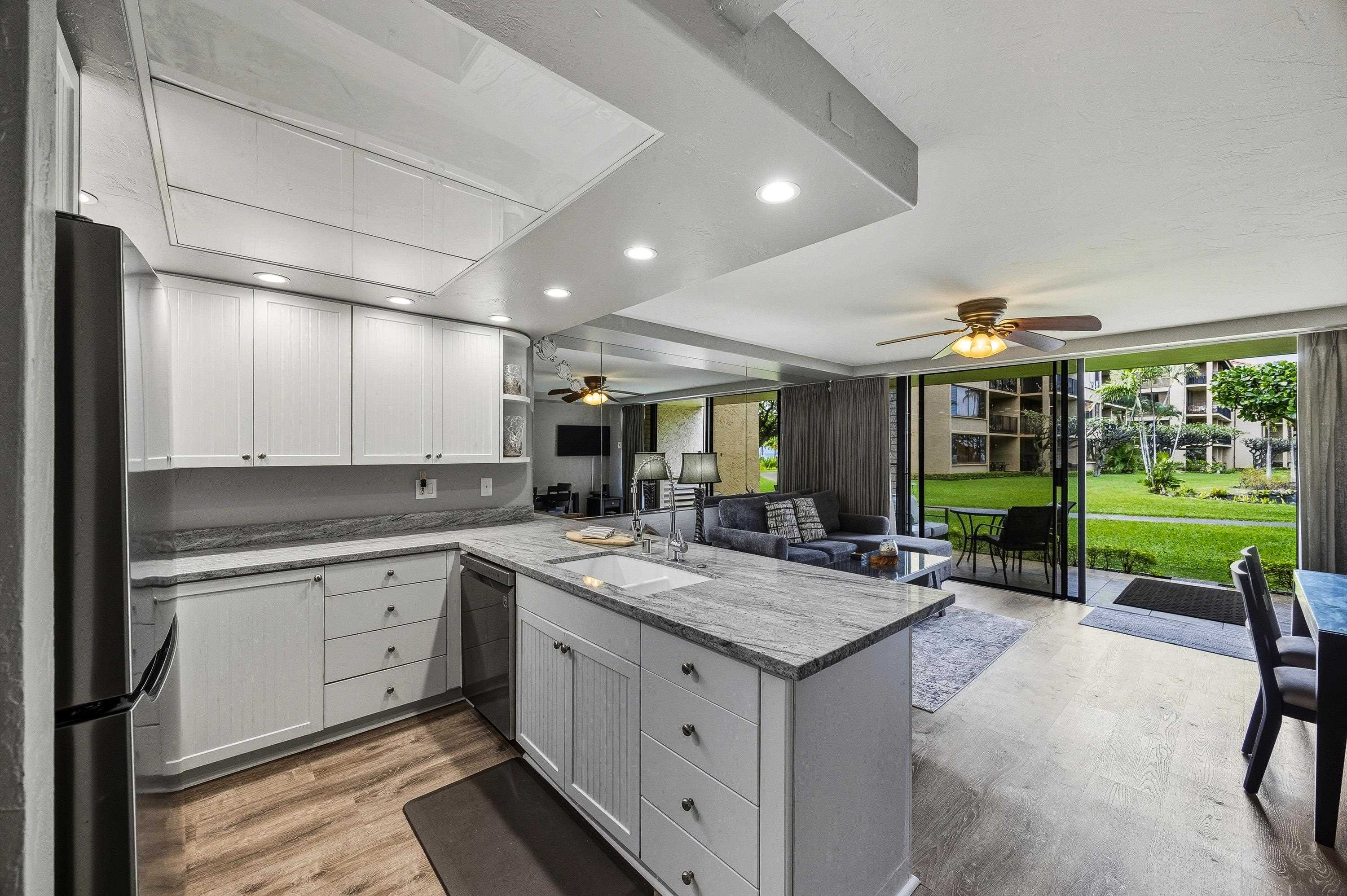 3543 Lower Honoapiilani Road, Unit H103 Lahaina, HI 96761 - Photo 11 of 50 a kitchen with sink refrigerator and view of living room