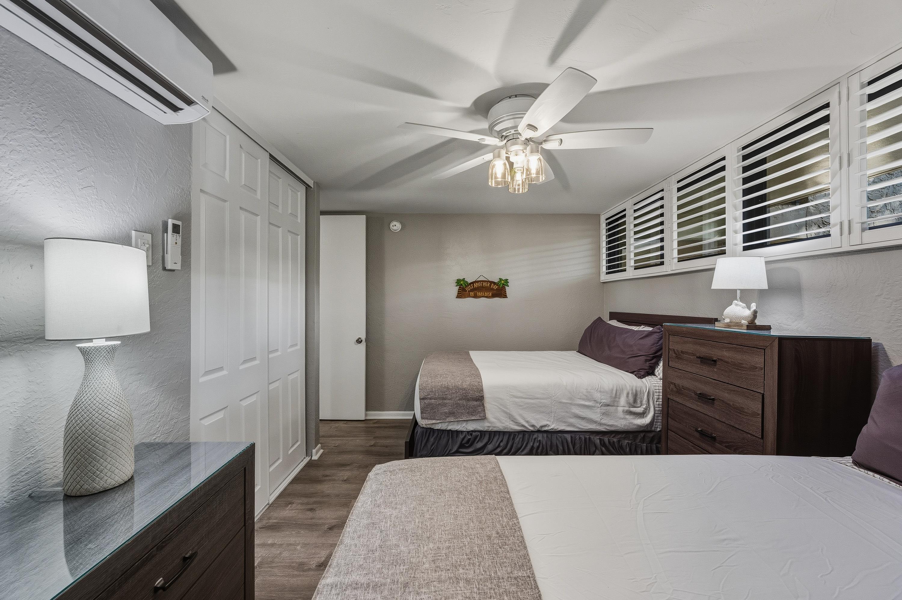 3543 Lower Honoapiilani Road, Unit H103 Lahaina, HI 96761 - Photo 15 of 50 a bedroom with furniture and a large window