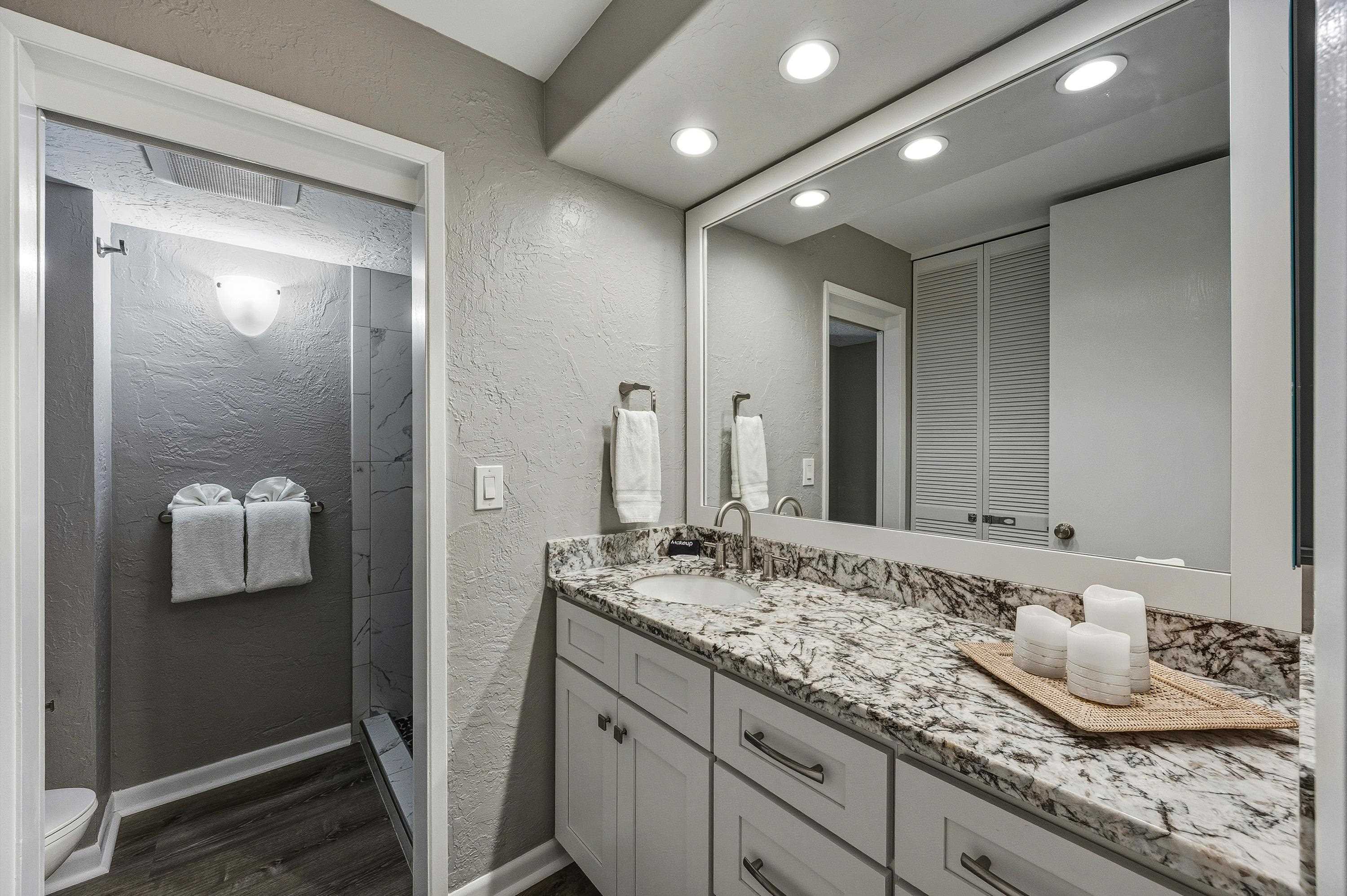 3543 Lower Honoapiilani Road, Unit H103 Lahaina, HI 96761 - Photo 17 of 50 a bathroom with a granite countertop sink and a mirror