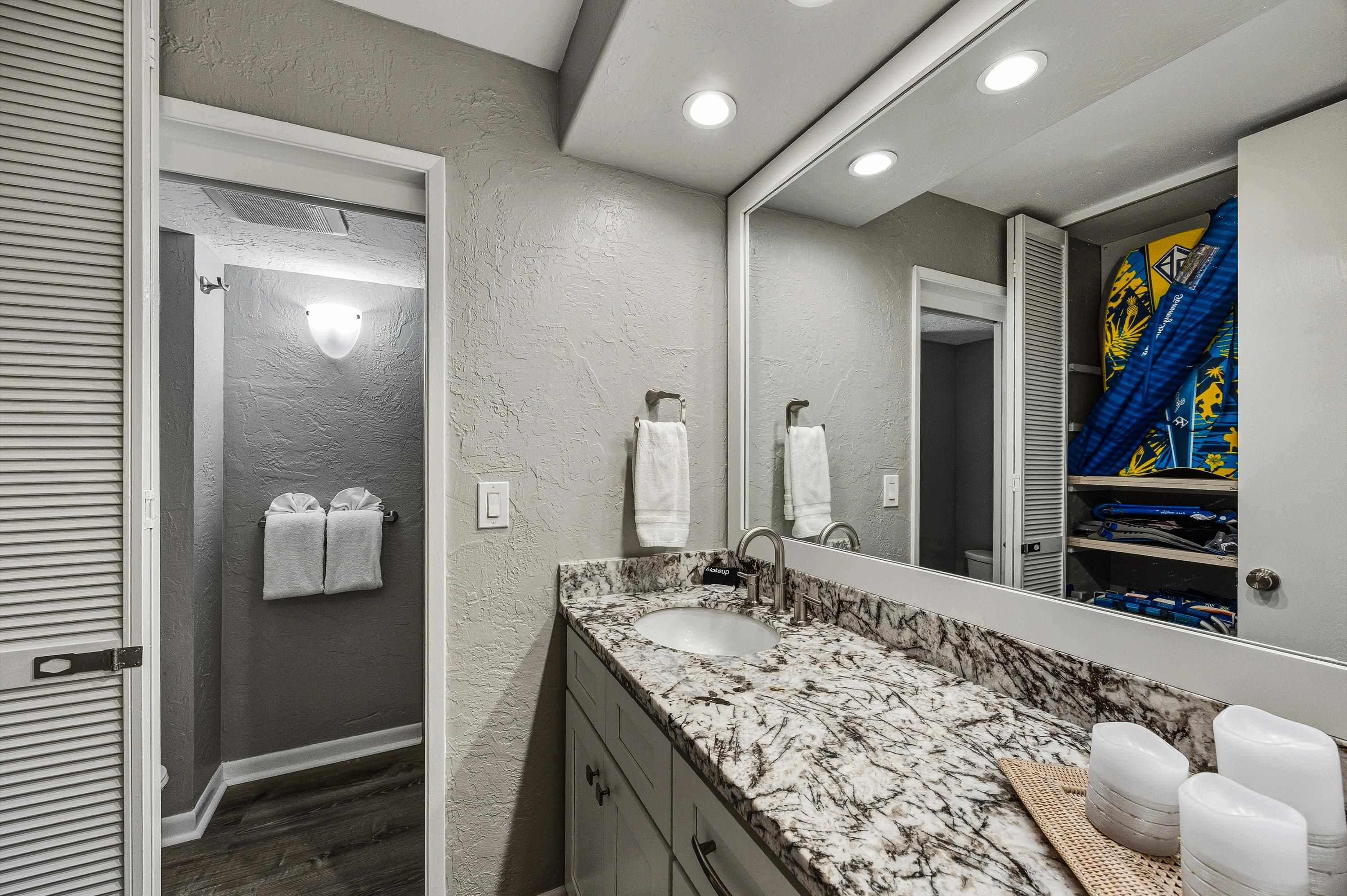 3543 Lower Honoapiilani Road, Unit H103 Lahaina, HI 96761 - Photo 19 of 50 a bathroom with a granite countertop sink and a mirror