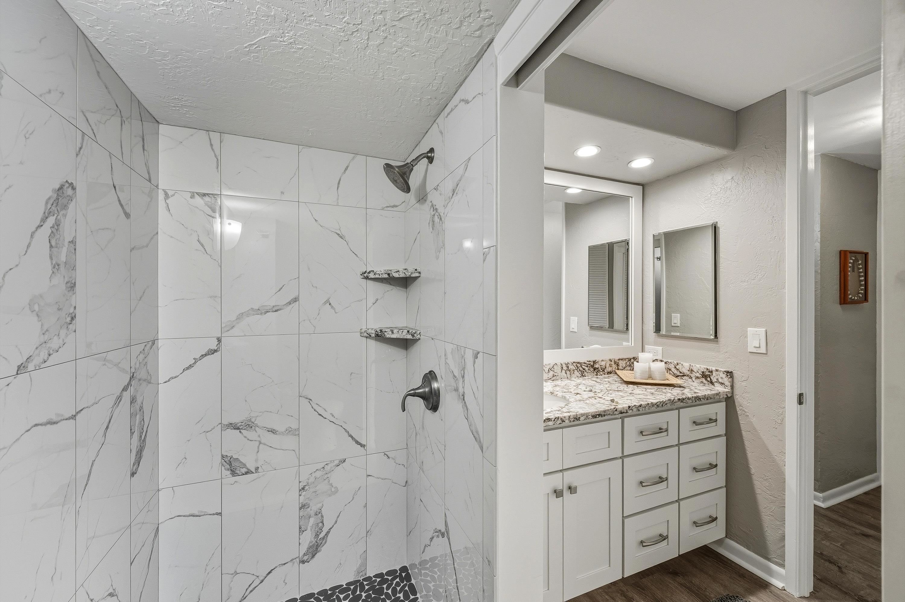 3543 Lower Honoapiilani Road, Unit H103 Lahaina, HI 96761 - Photo 20 of 50 a bathroom with a double vanity sink mirror and shower