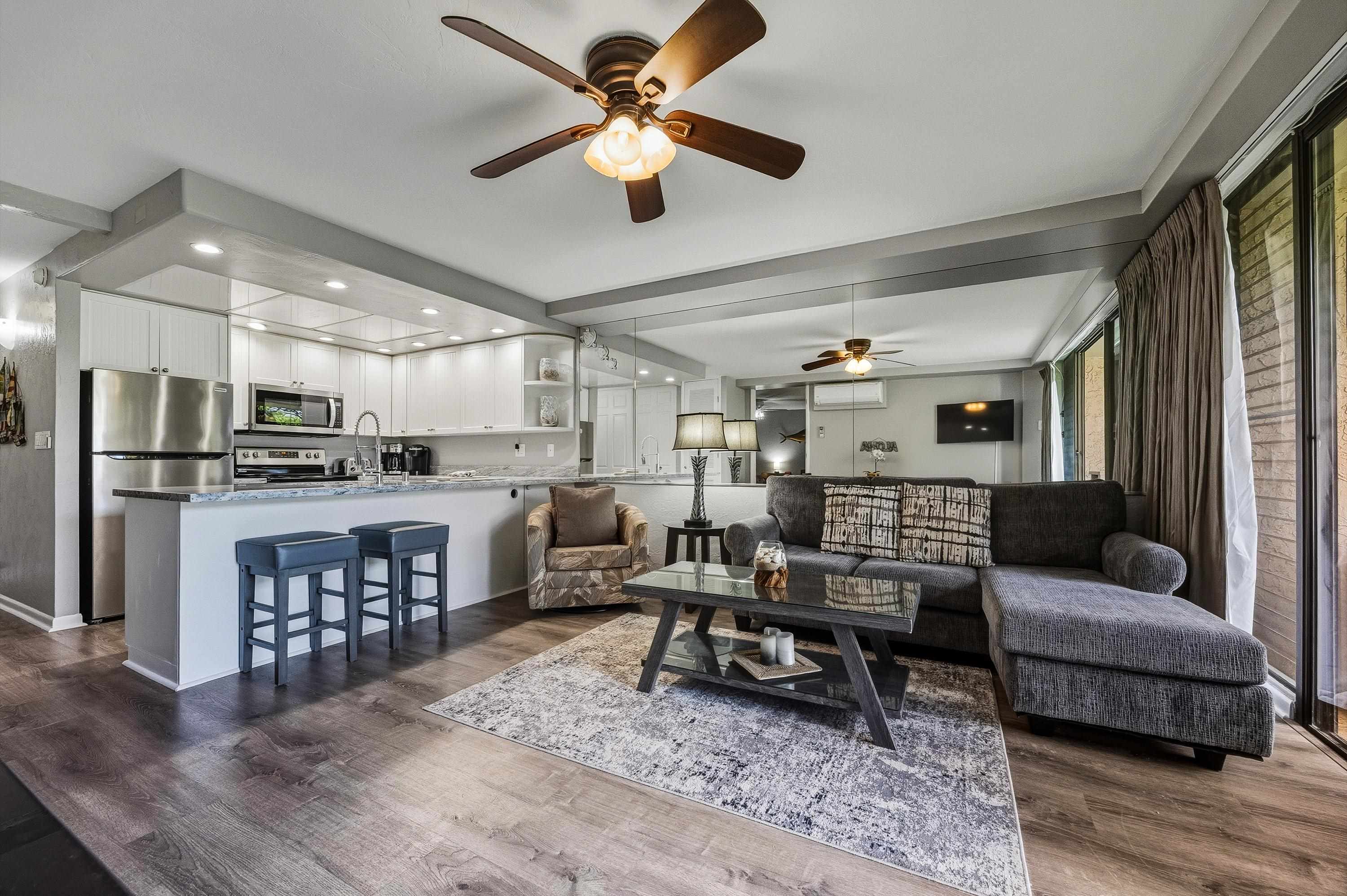 3543 Lower Honoapiilani Road, Unit H103 Lahaina, HI 96761 - Photo 2 of 50 a living room with furniture and a wooden floor