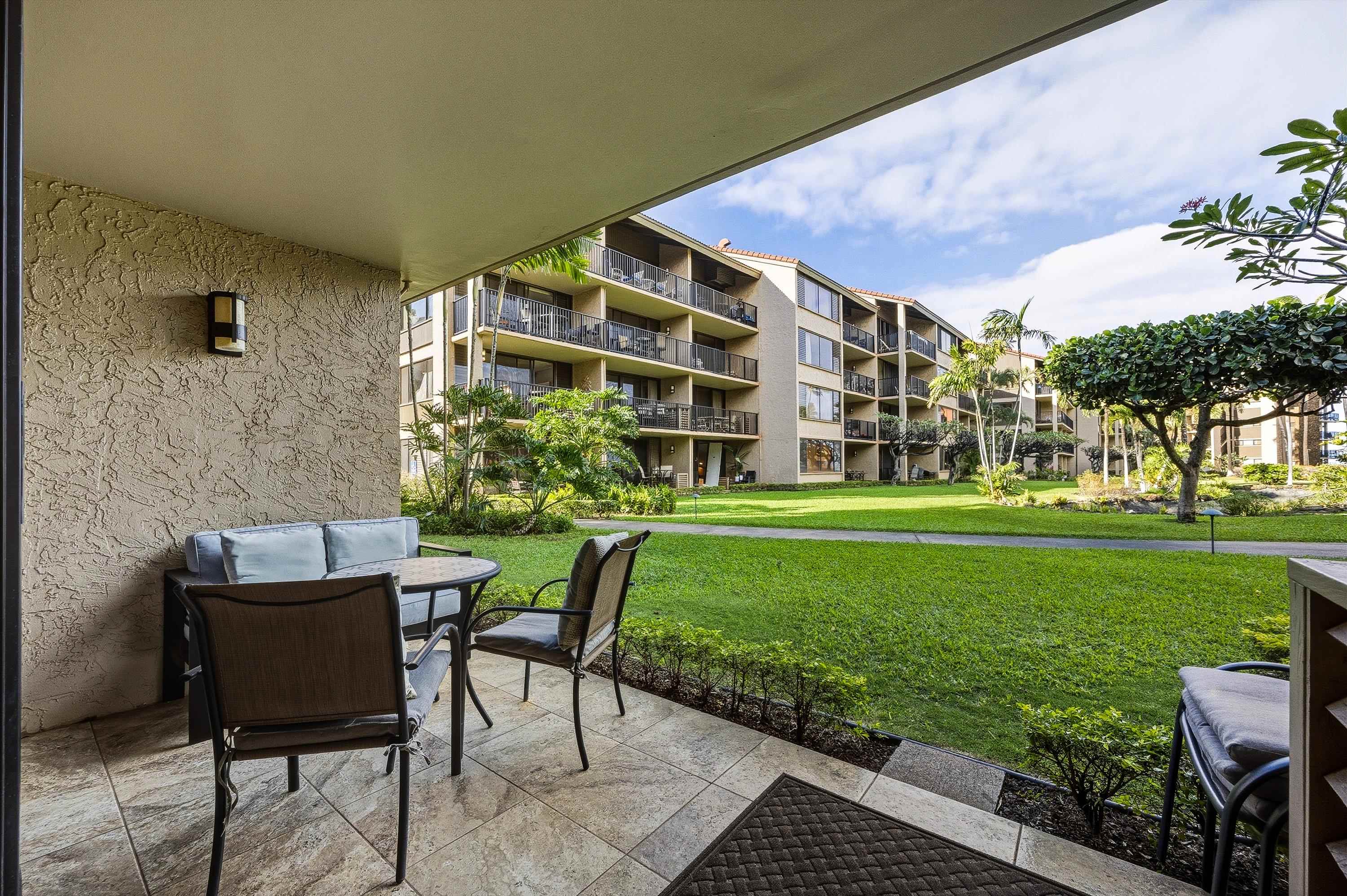 3543 Lower Honoapiilani Road, Unit H103 Lahaina, HI 96761 - Photo 33 of 50 a view of a chairs and a table in the garden