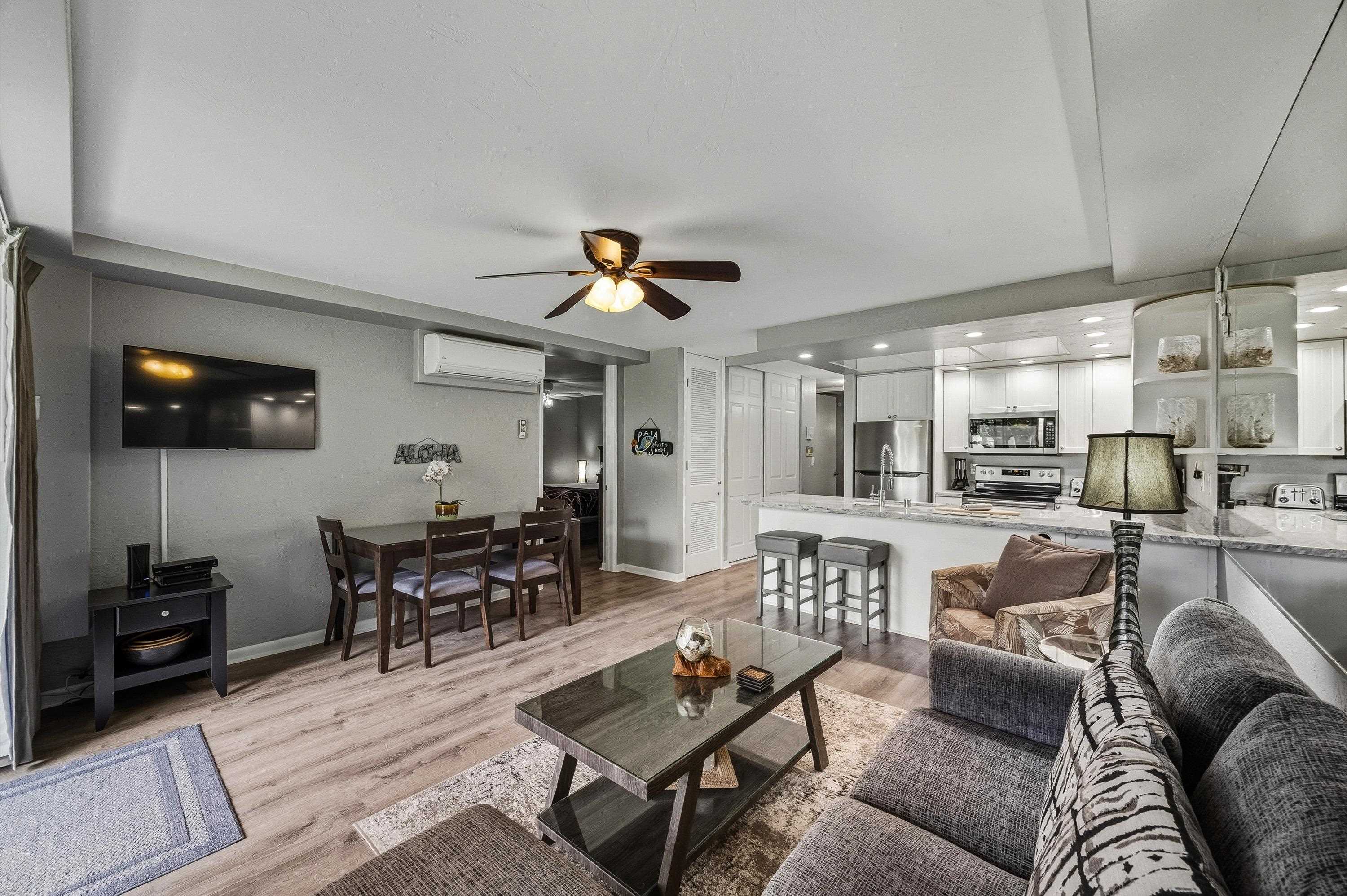 3543 Lower Honoapiilani Road, Unit H103 Lahaina, HI 96761 - Photo 4 of 50 a living room with furniture and a flat screen tv