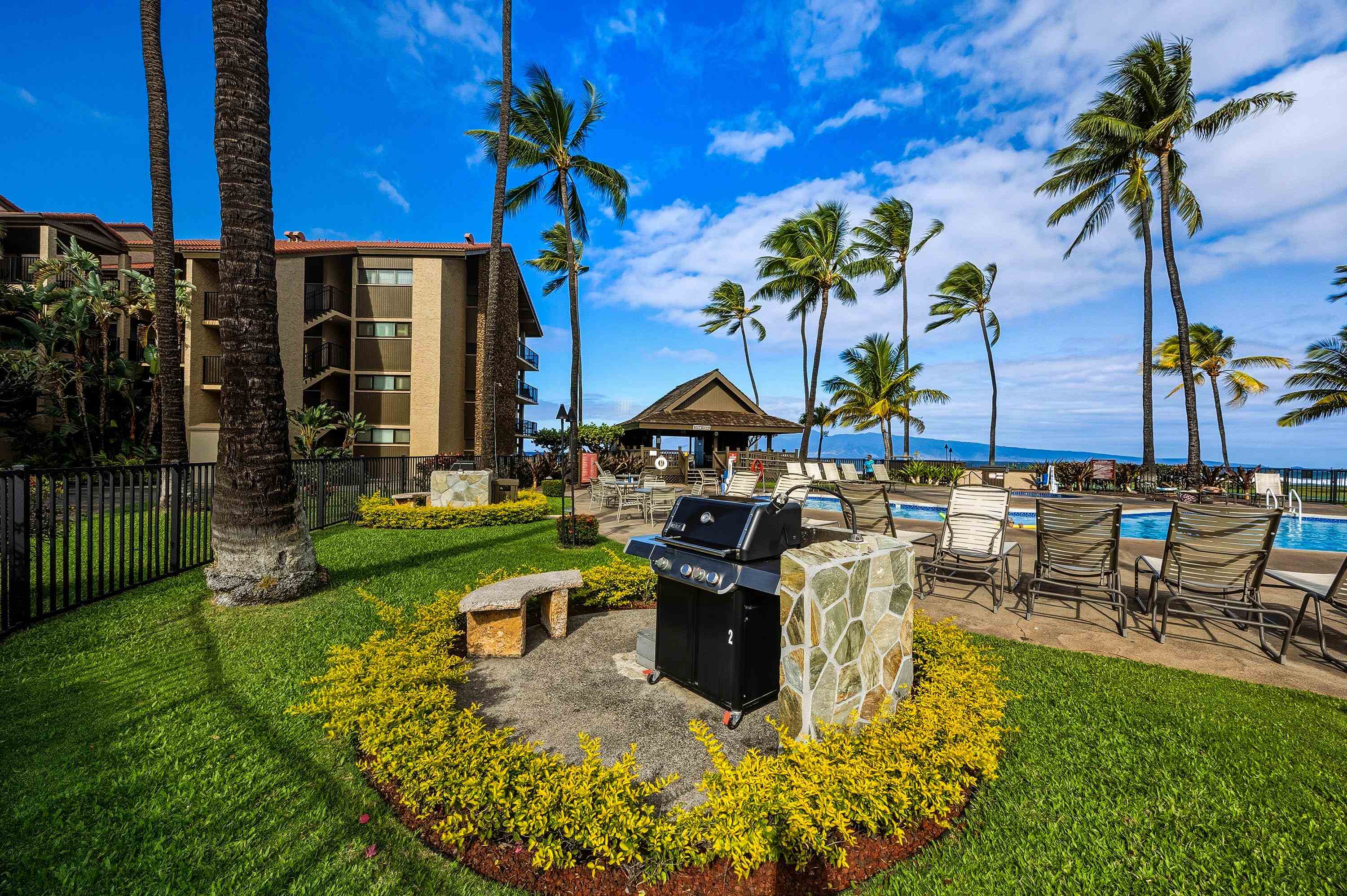 3543 Lower Honoapiilani Road, Unit H103 Lahaina, HI 96761 - Photo 41 of 50 a view of a swimming pool with a table and chairs