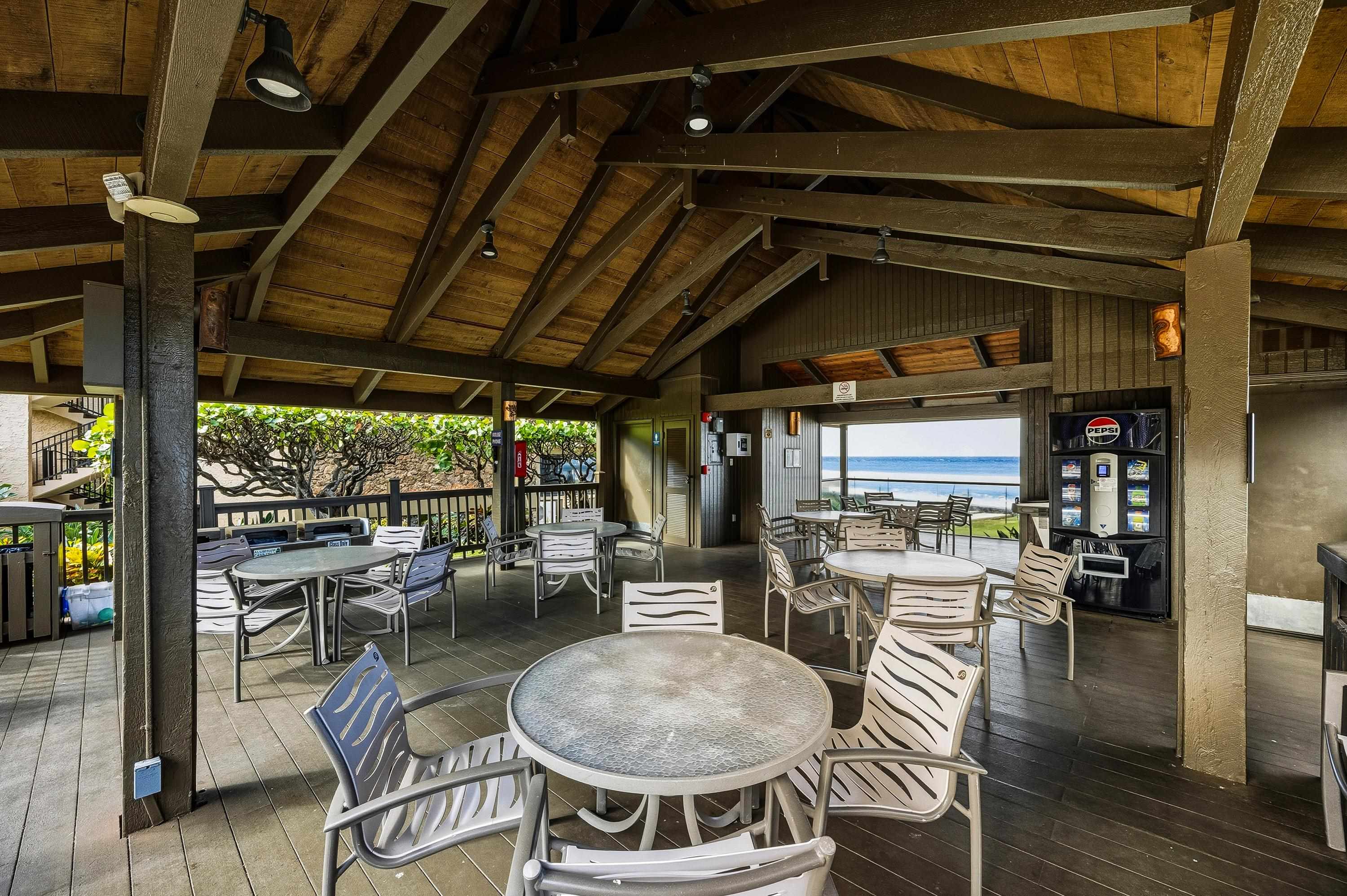 3543 Lower Honoapiilani Road, Unit H103 Lahaina, HI 96761 - Photo 42 of 50 a dining room with furniture and wooden floor
