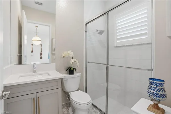 a bathroom with a sink toilet and shower