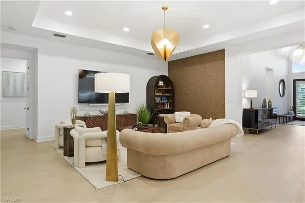 a living room with furniture and a chandelier