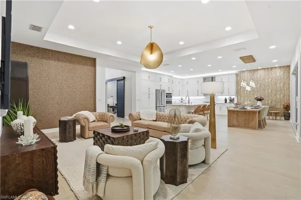 a living room with furniture and kitchen view