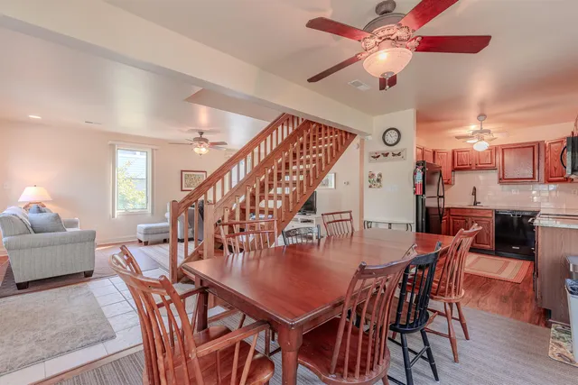 a dining room with furniture and wooden floor