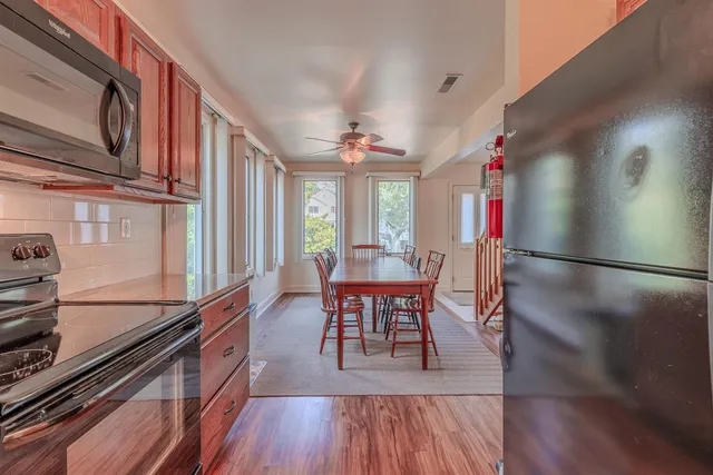 a view of a dining room with furniture window and wooden floor