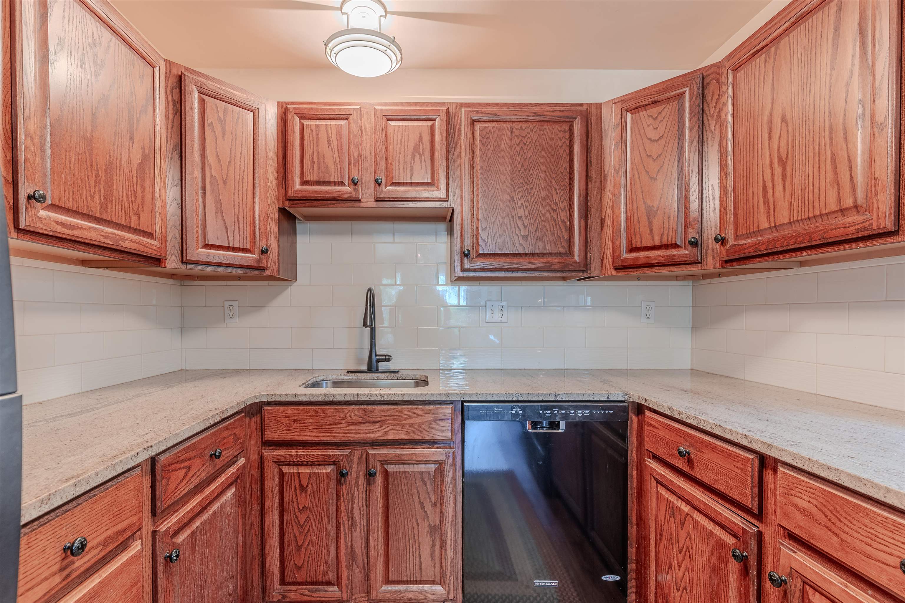 323 Alexander Avenue Cape May Point, NJ 08212 - Photo 15 of 50 a kitchen with stainless steel appliances granite countertop wooden cabinets a sink and dishwasher
