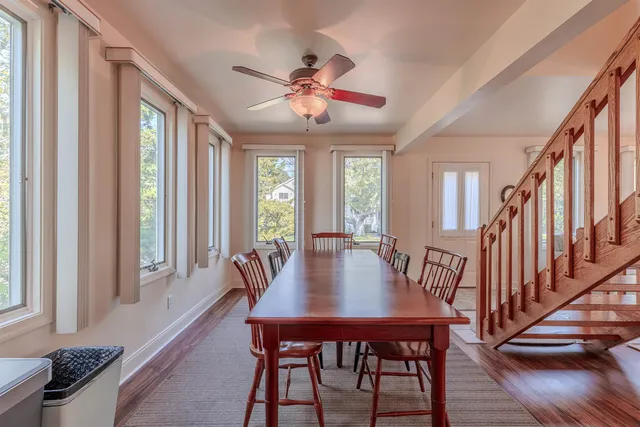 a view of a dining room with furniture window and wooden floor