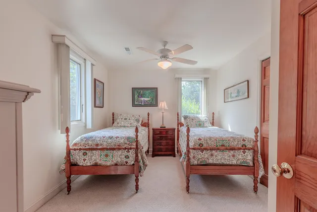 a bedroom with two beds and window