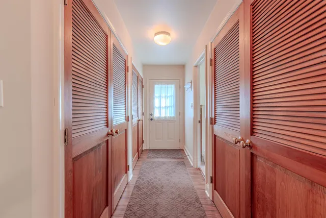 a view of hallway with stairs and a window