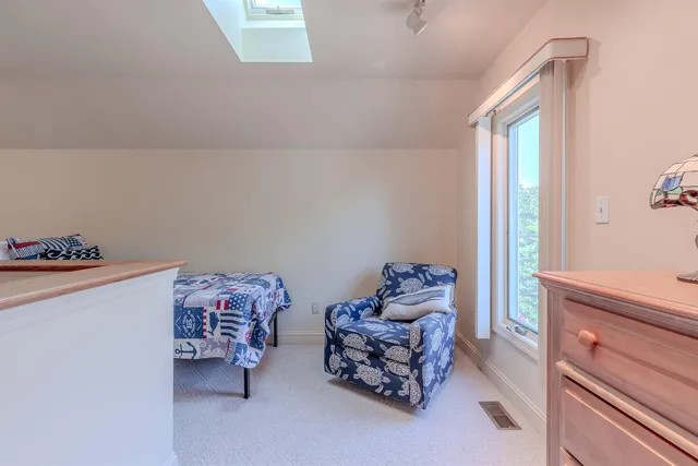 a bedroom with furniture and a window