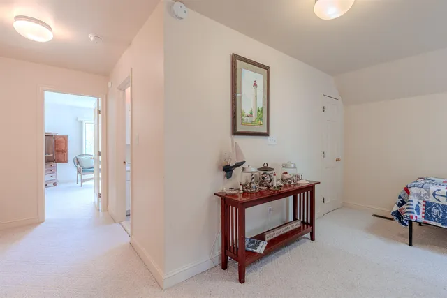 a hallway with a baby crib and a dresser