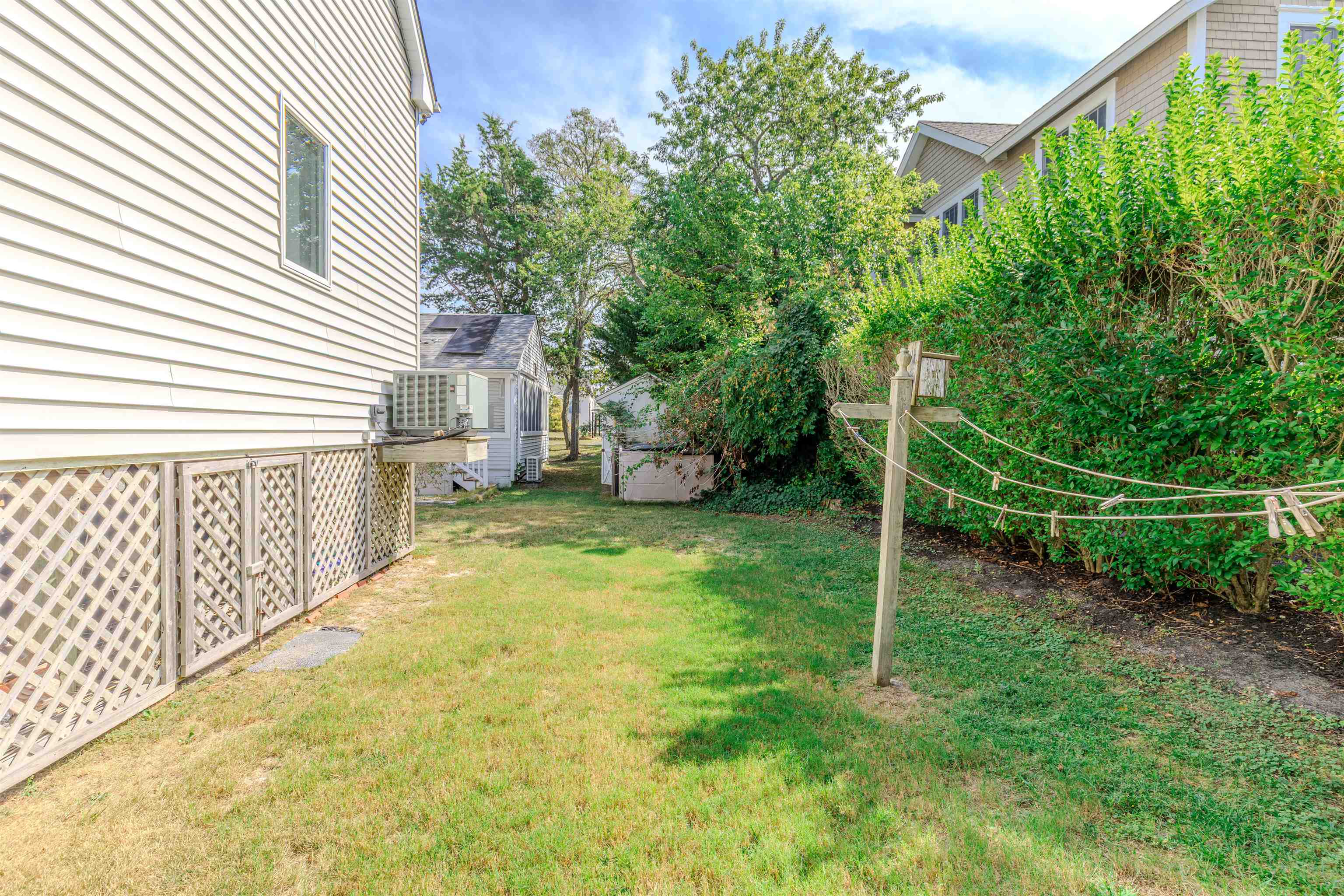 323 Alexander Avenue Cape May Point, NJ 08212 - Photo 47 of 50 a backyard of a house with plants and entertaining space