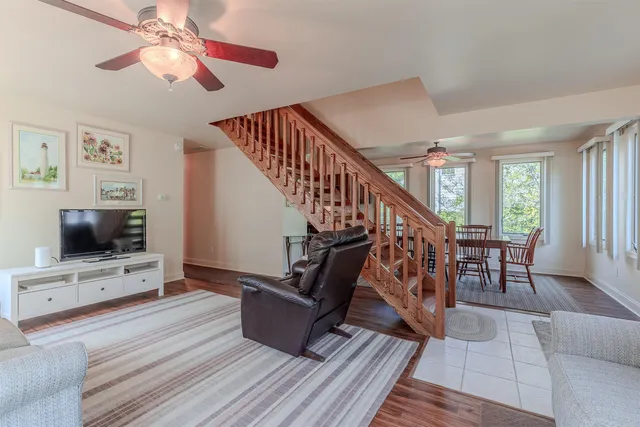 a view of staircase with furniture and a flat screen tv
