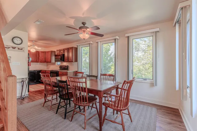 a view of a dining room with furniture window and wooden floor
