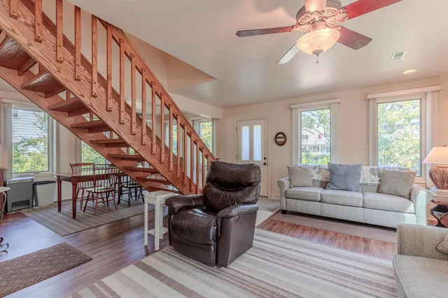 a living room with furniture and wooden floor