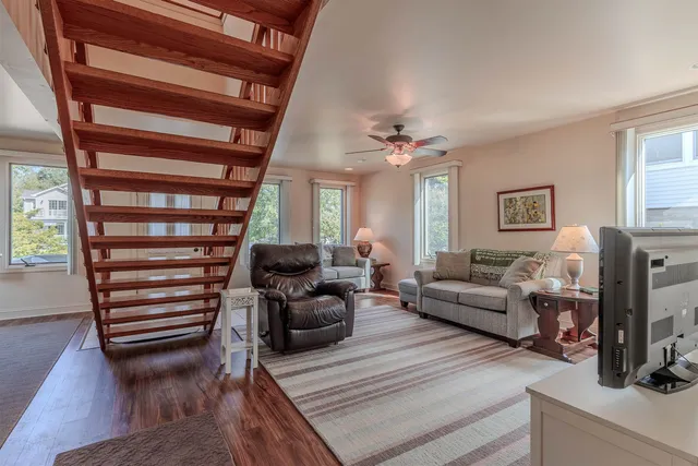 a living room with furniture a rug and a fireplace