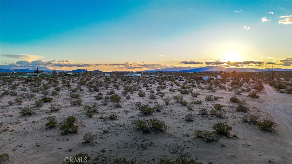 0 Cypress Rd. Road Joshua Tree, CA 92252 - Photo 27 of 33 a view of a large building with mountains in the background