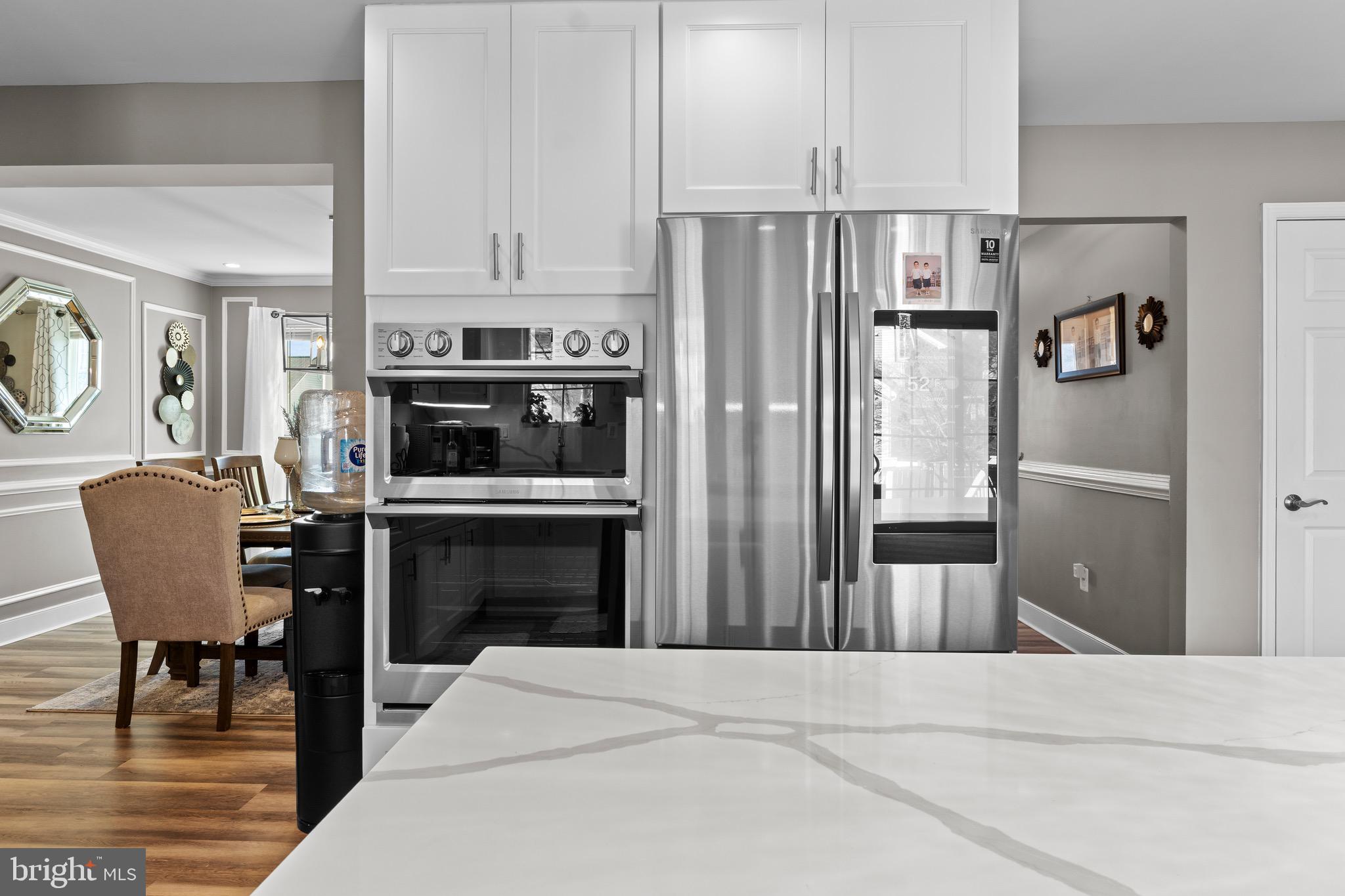1735 Canal Run Drive Point of Rocks, MD 21777 - Photo 17 of 59 a kitchen with stainless steel appliances a stove a refrigerator and a fireplace
