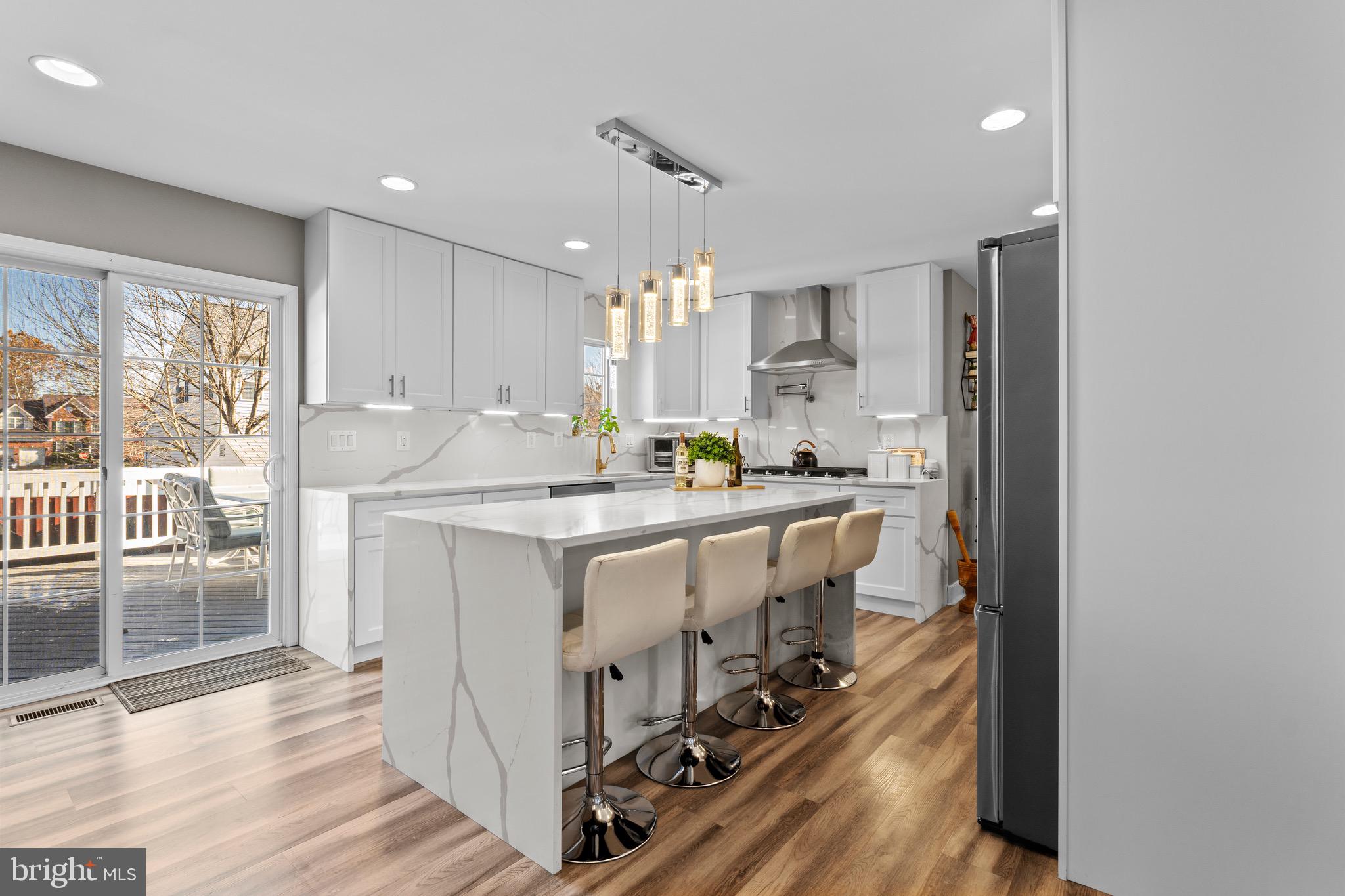 1735 Canal Run Drive Point of Rocks, MD 21777 - Photo 21 of 59 a kitchen with kitchen island granite countertop a sink cabinets and wooden floor