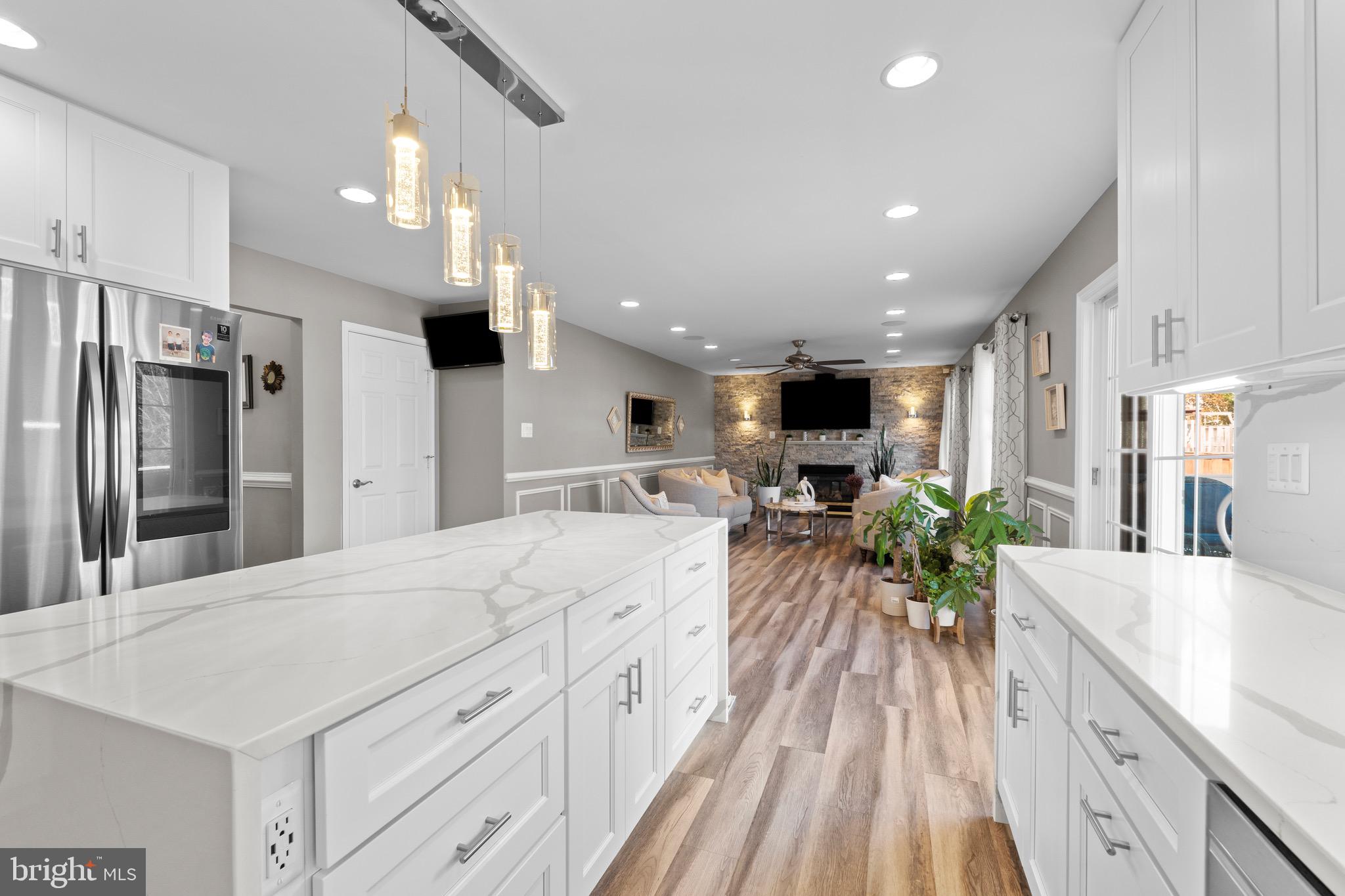 1735 Canal Run Drive Point of Rocks, MD 21777 - Photo 22 of 59 a large white kitchen with a large window a refrigerator and a sink