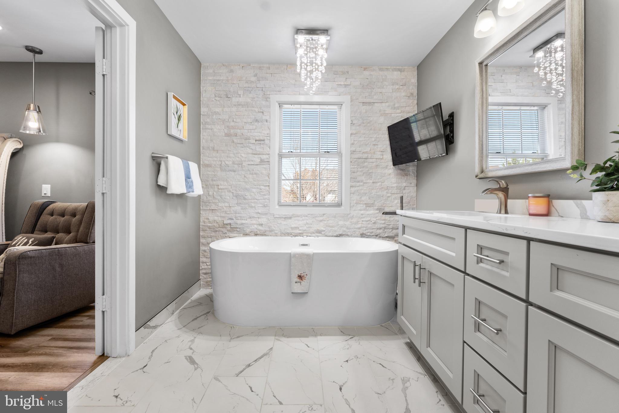 1735 Canal Run Drive Point of Rocks, MD 21777 - Photo 33 of 59 a bathroom with a tub sink and mirror