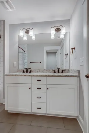 a bathroom with a sink vanity and mirror