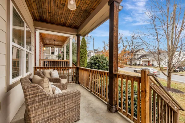 a balcony view with a large window and furniture