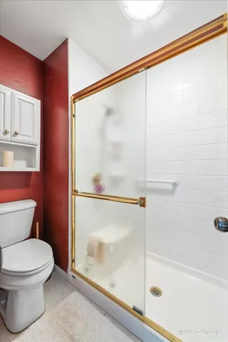 a bathroom with a toilet and a shower