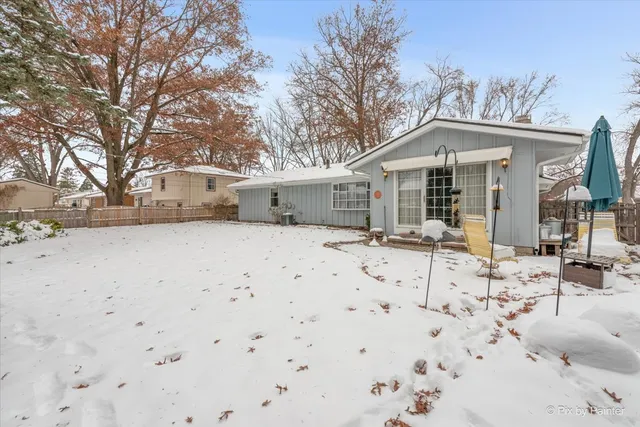 a view of a house with a yard covered in snow