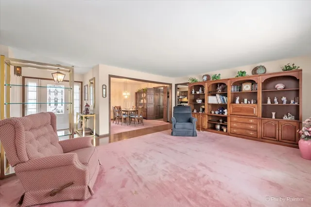 a bedroom with furniture and a large window