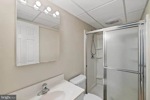 a bathroom with a shower and a sink