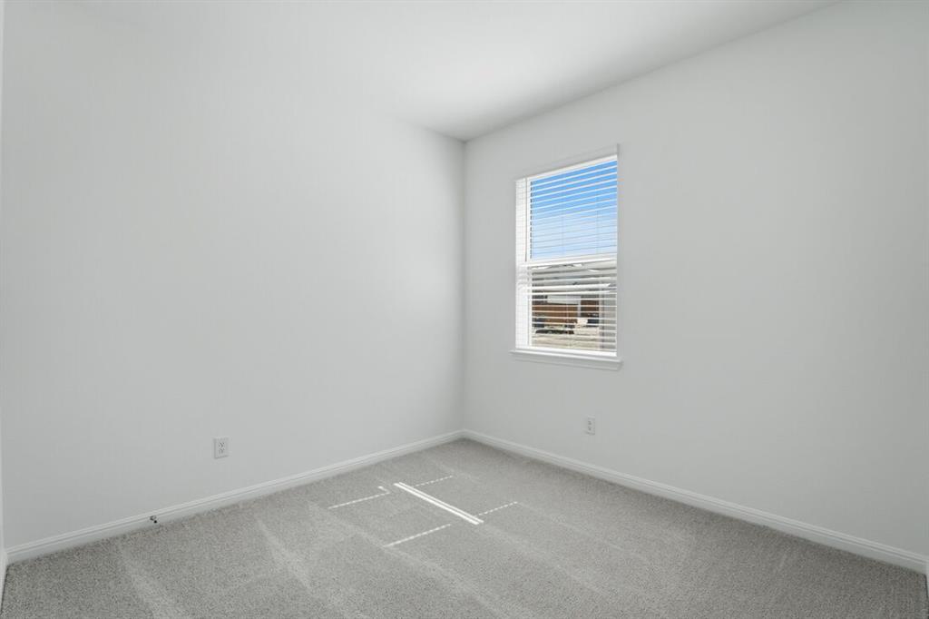 201 Betsy Road Hutto, TX 78634 - Photo 16 of 18 The property features a room with light gray carpet, white walls, and a window with blinds