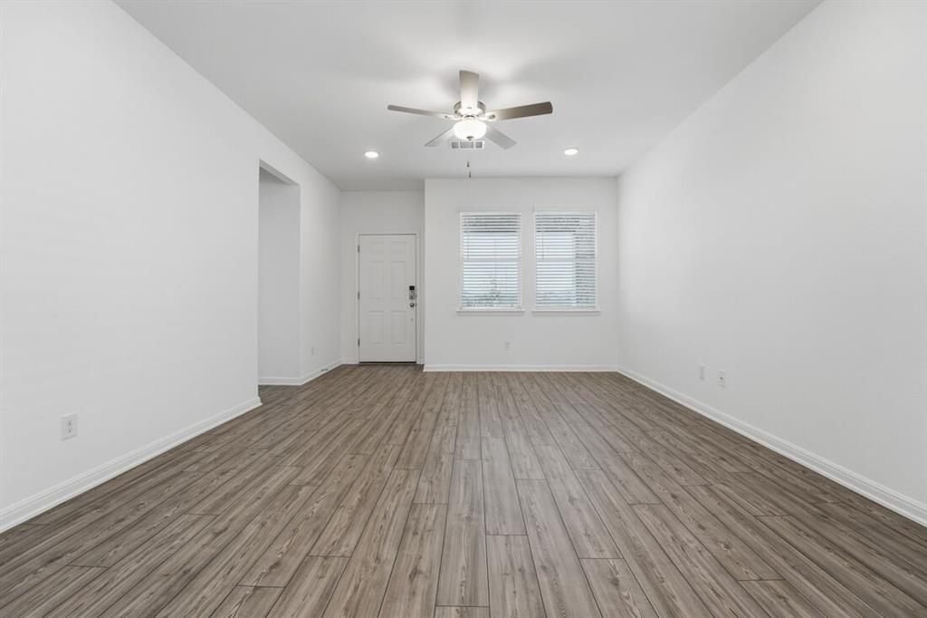 201 Betsy Road Hutto, TX 78634 - Photo 10 of 18 Spacious room featuring wood-look flooring, light-colored walls, and a ceiling fan with integrated lighting
