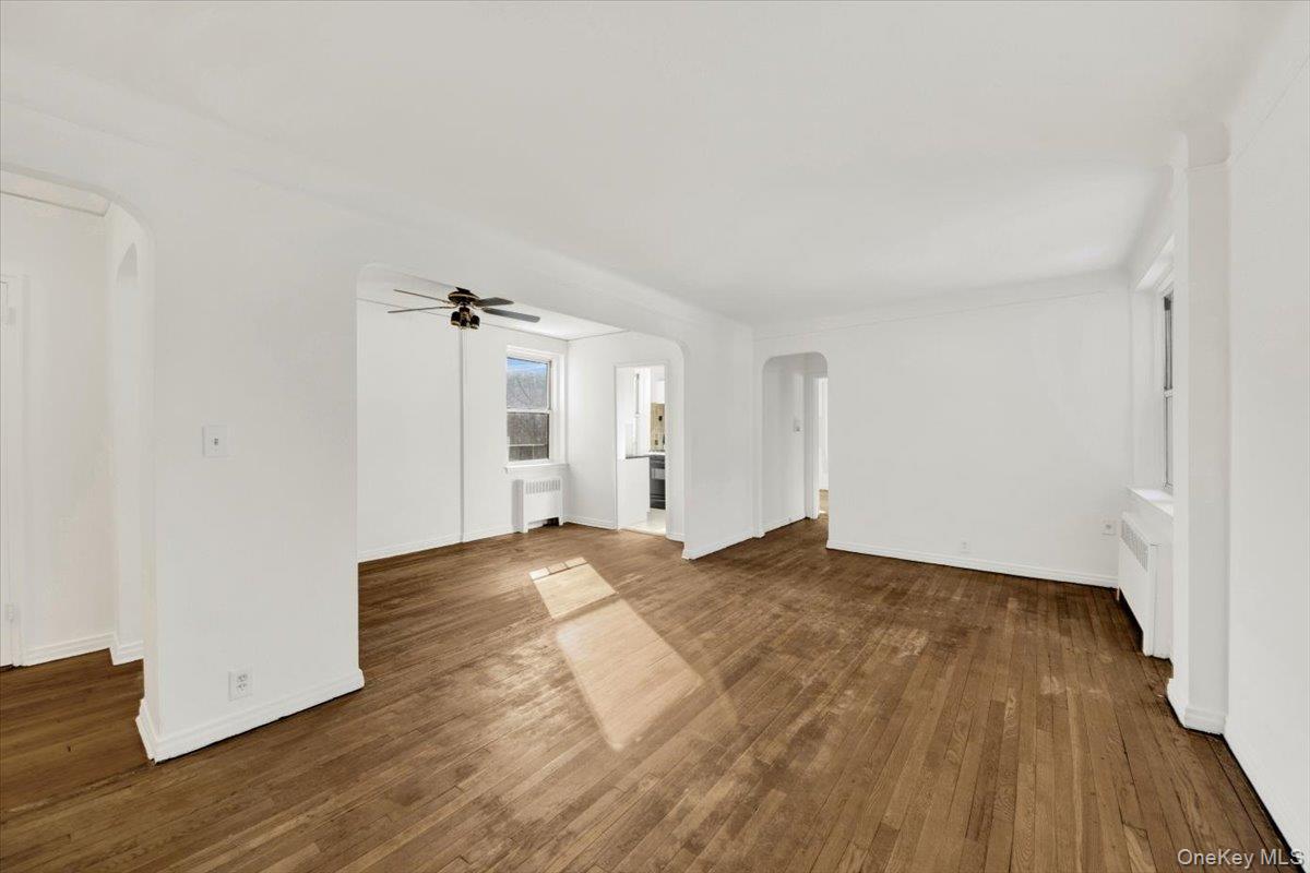 811 Bronx River Road, Unit 3C Bronxville, NY 10708 - Photo 11 of 27 a view of empty room with wooden floor and ceiling fan