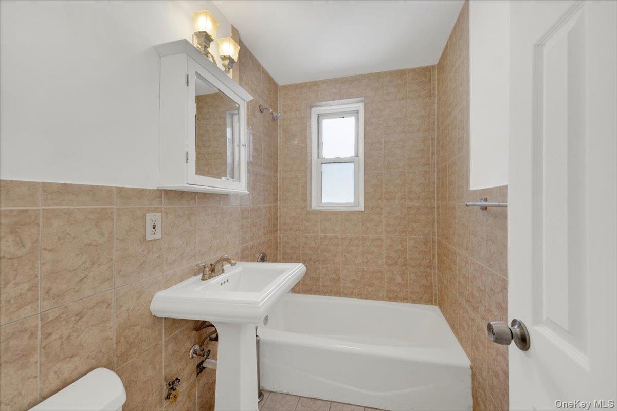 811 Bronx River Road, Unit 3C Bronxville, NY 10708 - Photo 17 of 27 a bathroom with a sink a toilet and shower