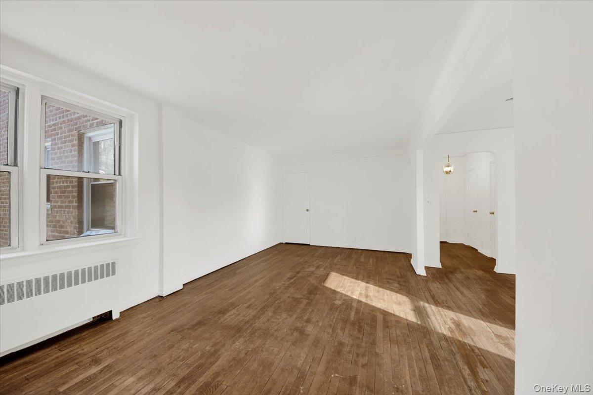 811 Bronx River Road, Unit 3C Bronxville, NY 10708 - Photo 8 of 27 a view of an empty room with wooden floor and a window