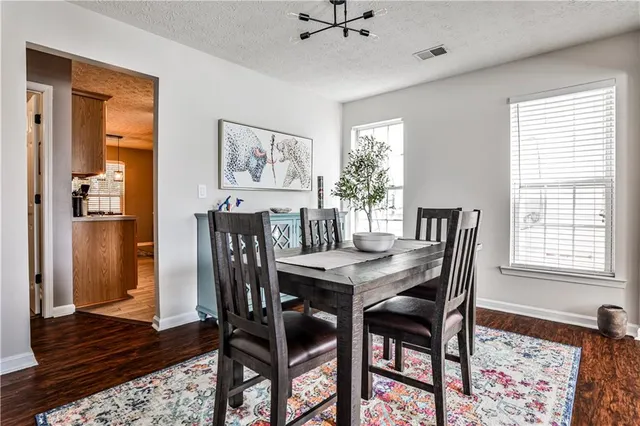 a view of a dining room with furniture and window