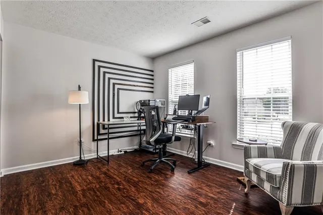 a view of a livingroom with lounge chair and a window