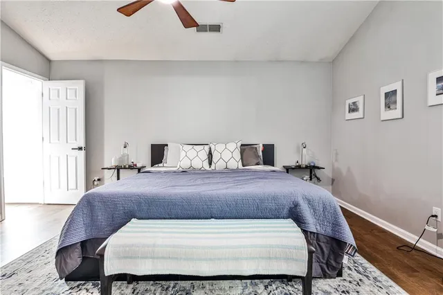a bedroom with a bed and wooden floor